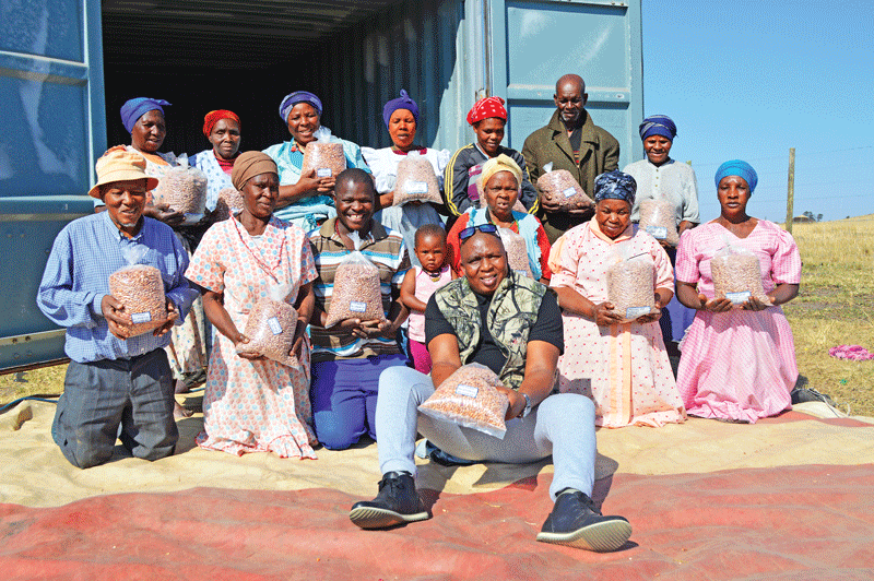 Beneficiary community members with harvested produce